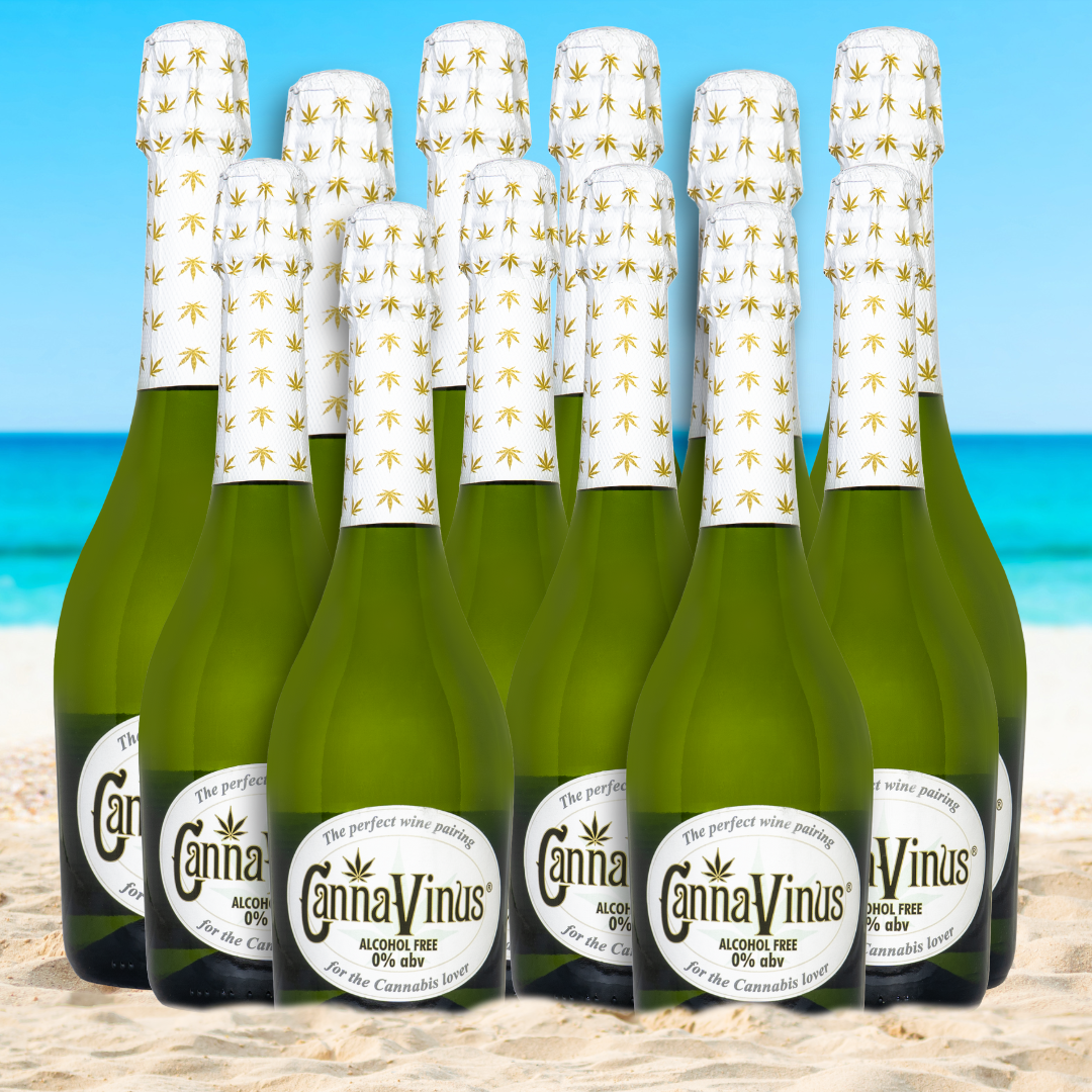 12 750ml bottles of CannaVinus on the beach with water in the background