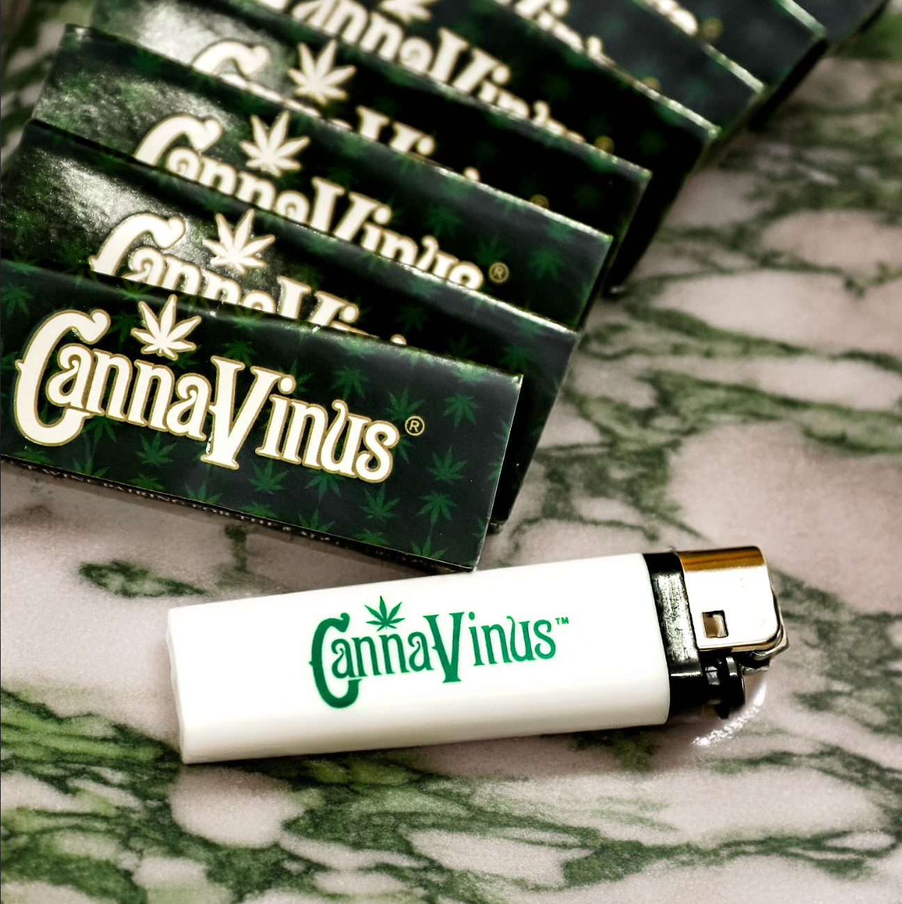 Canna Vinus Lighter with Canna Vinus Rolling papers stacked behind it