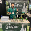 CannaVinus owner with a bottle of cannavinus in his hand in a booth at a show