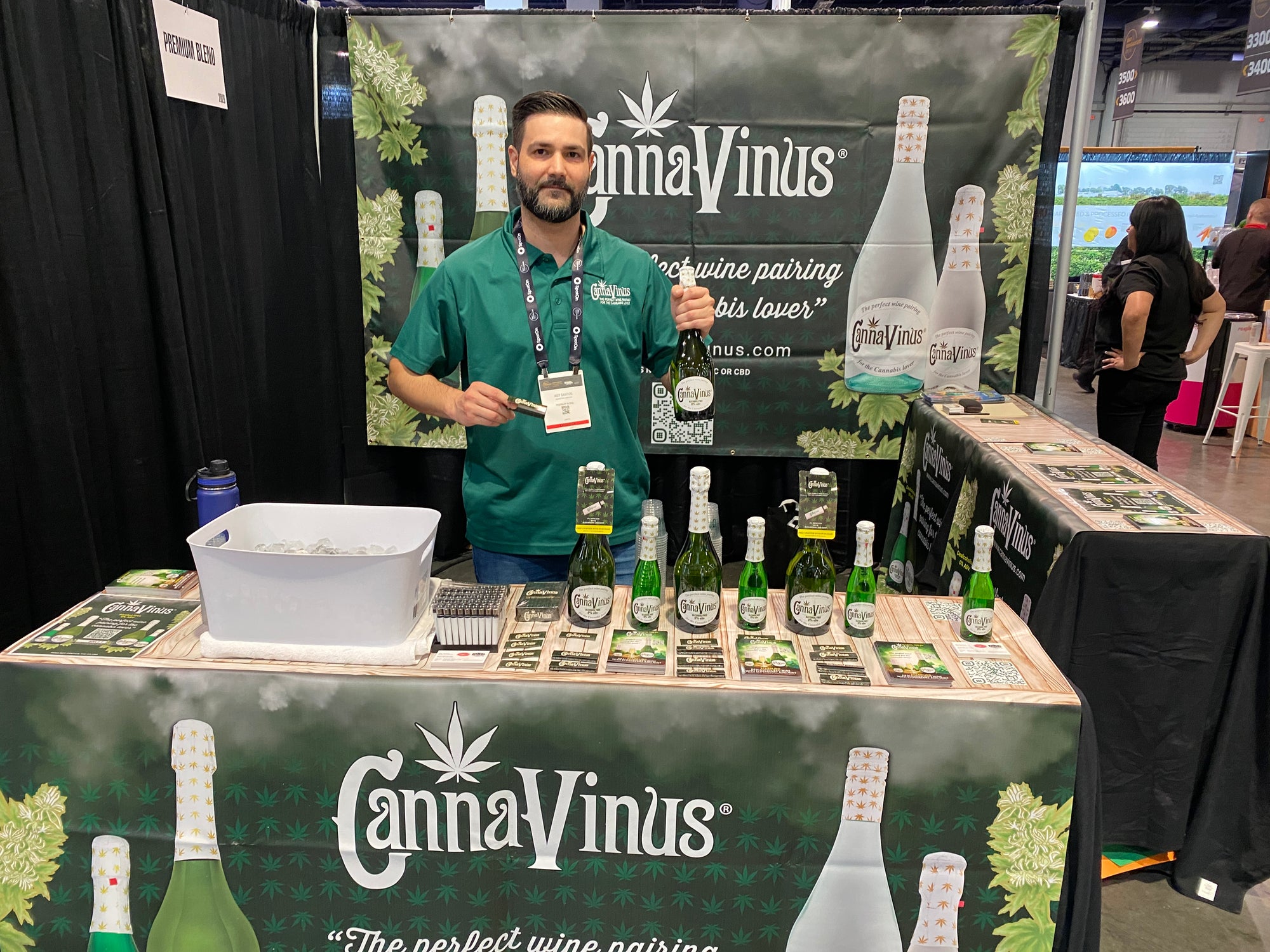 CannaVinus owner with a bottle of cannavinus in his hand in a booth at a show