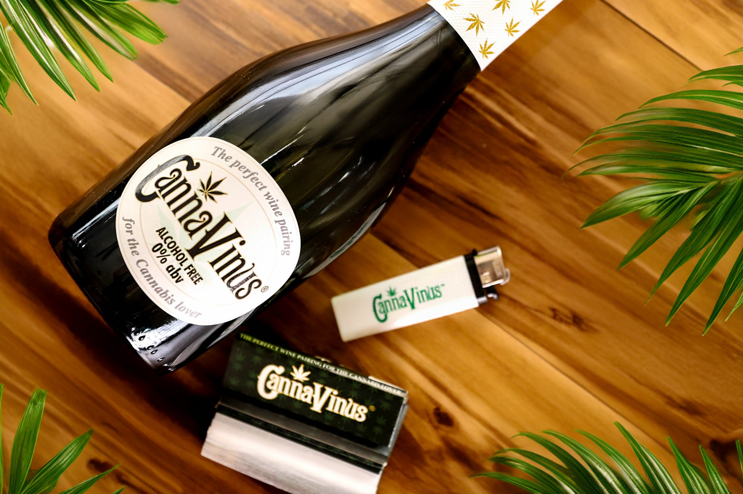 Bundle 1 with a 750ml Canna Vinus Bottle a Canna Vinus Lighter and Canna Vinus rolling papers on a table